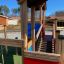 Wooden Tower playhouse with slide in a playground