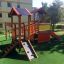 Tower playhouse with slide in a playground