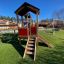 Tower playhouse with slide on playground.