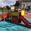 Tower playhouse with slide in a playground.