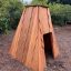 Small Tipi wooden house in a park setting.