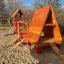 Wooden playground structure with slide and hut, Lasse's House.