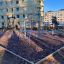 Outdoor playground with Cassiopeia, steel structure climbing frame and swings.