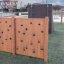Kids outdoor Climbing Wall with wooden panels in a playground.