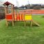 Fortress playhouse with slide on grass playground