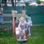 Children playing on Fortress playhouse with slide.