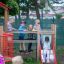 Children playing on the Fortress playhouse with slide.