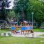 Fortress playhouse with slide in a green park