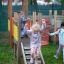 Children playing on Fortress playhouse with slide.