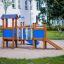 Fortress playhouse with slide in a playground.