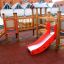 Fortress playhouse with slide on a playground.
