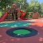 Round trampoline (80 cm) in a colorful outdoor playground.