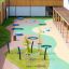 Round trampoline (150 cm) on colorful playground surface with safety net and black frame