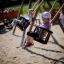 Children enjoying a ride on a Double Baby Swing on a playground.