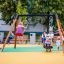 Children enjoying a ride on the Double Swing playground equipment.