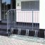 Bicycle rack Cross 5 installed in front of a building entrance.