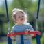 Child on Double Swing in playground.