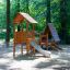 Galapagos wooden playhouse with slide in forest playground setting