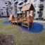 Galapagos wooden playhouse with slide located in a residential apartment complex.