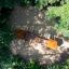 Galapagos wooden playhouse with slide aerial view surrounded by trees