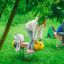Children playing on Grasshopper rocking spring riders in a green playground.