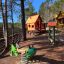 Grasshopper rocking in a colorful playground with wooden houses.