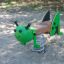Green Grasshopper Rocking toy for children in a playground.