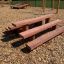 Wooden Stairs playground equipment on a wood chip surface.