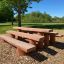 Outdoor wooden bench named Stairs in a park setting