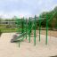 Green outdoor fitness structure, Grandis Training Set, in park with sand base.