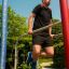 Man exercising on outdoor fitness equipment from Scala Training Set.