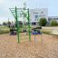 Outdoor Scala Training Set in a playground with a green climbing structure and other fitness equipme