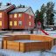 Octagon Arena I in a playground with a red slide and climbing structure.