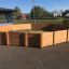 Outdoor wooden sports arena, Octagon Arena II, in the middle of a playground.