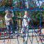 Children playing on Autan climbing net playground equipment outdoors