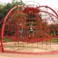 Children playing on Boreas climbing net in a park.