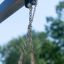 Chains and connectors of Swing Seat SSL attached to a frame outdoors.