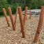 Wooden playground equipment Mojave (6 pcs set) installed outdoors in a natural setting.
