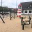 Lighthouse single playhouse with climbing net in a playground.