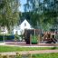 Blackboard 156 cm on a modern playground surrounded by greenery and houses.