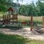 Triple Hammock set in a playground with wooden equipment and benches.