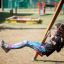 Girl swinging on Twister w/ swing in a playground