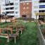 Outdoor playground with Balance Course equipment near apartment buildings.
