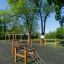 Trim trail outdoor playground obstacle course with wooden climbing structures and ropes on safety su
