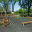 Trim trail outdoor fitness obstacle course made of wooden beams and ropes in a park setting