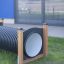 Obstacle Tunnel outdoor play equipment in grassy area.