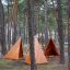 Tipi Nature wooden house playground set among pine trees