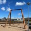 Nature Double Swing 5m in a playground with wooden frame and two seats