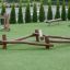 Nature Balancer playground equipment made of wooden logs on artificial grass