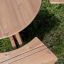 Round table & benches on grass background.